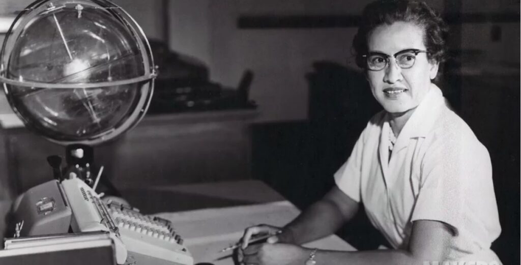 Image of Katherine Johnson sitting at her desk